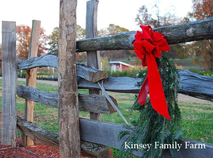 A wreath with a red bow on a wooden fence at Kinsey Family Farm.