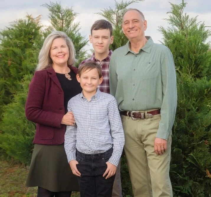 A family among the Christmas trees at Tom’s Trees.