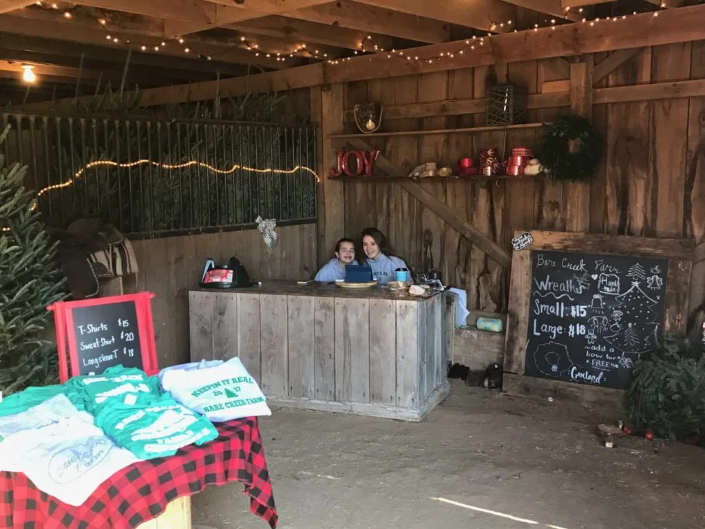 Visitors at the rustic counter inside Bare Creek Farm’s barn.