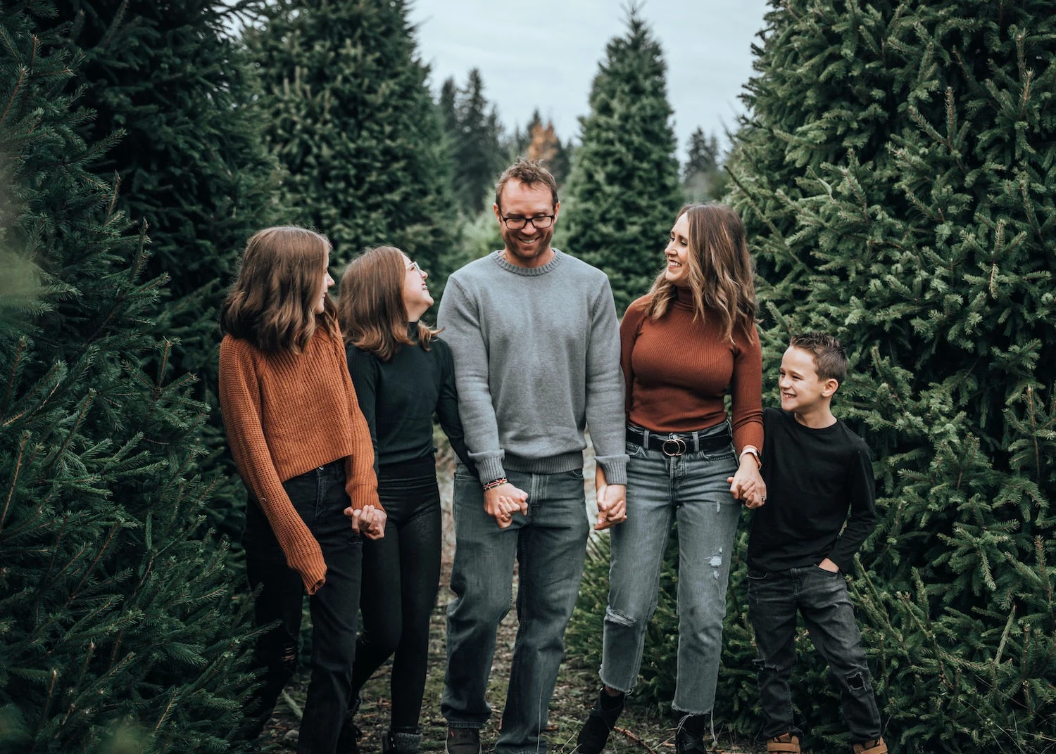 A family among trees at Hunter Family Farm.