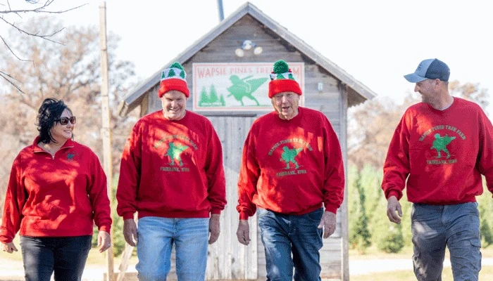 The Wapsie Pines farm family outside a tree-farm building