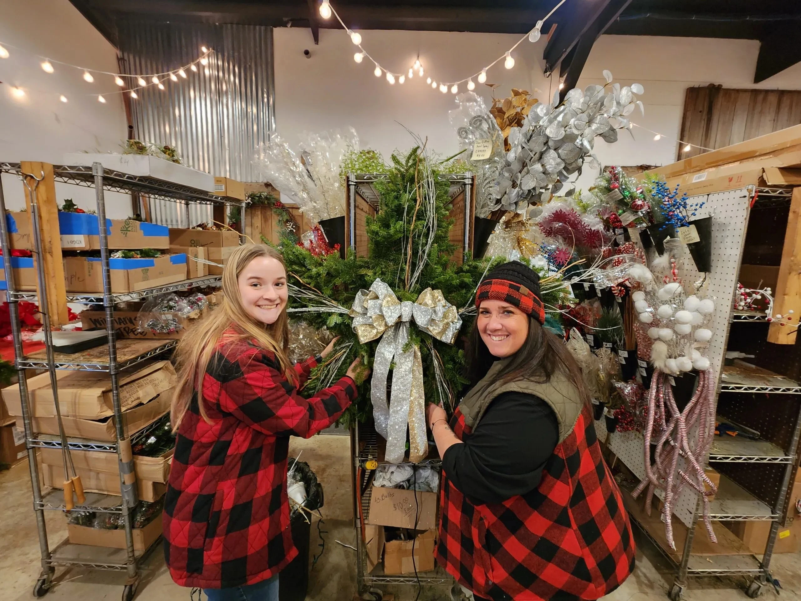 Visitors with a wreath inside Williams Tree Farm’s Christmas shop