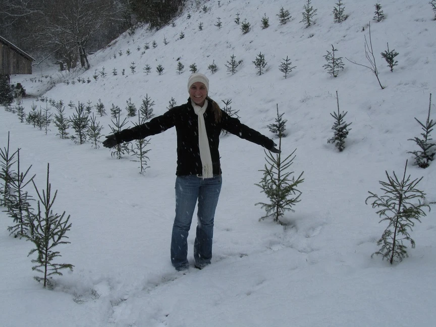 A person among snow-covered trees at Wilson Glyn Farm.